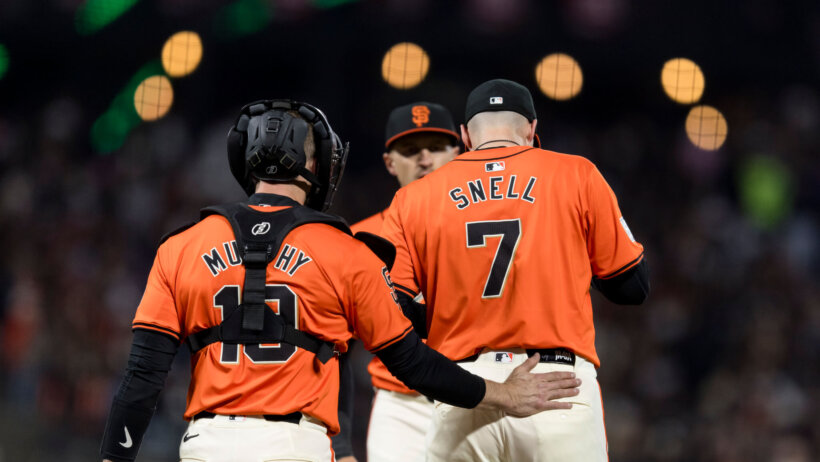 San Francisco Giants catcher Tom Murphy talks to starting pitcher Blake Snell