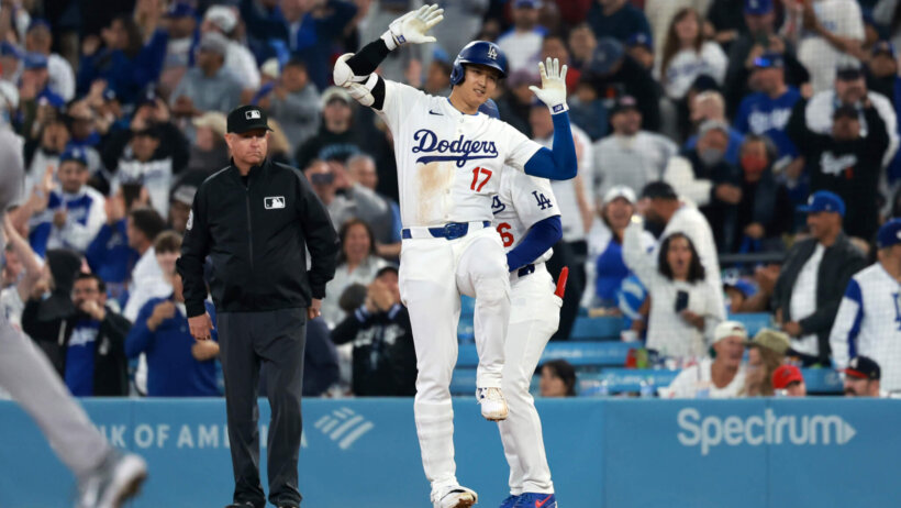Los Angeles Dodgers designated hitter Shohei Ohtani reacts after hitting an RBI single during the tenth inning against the Atlanta Braves