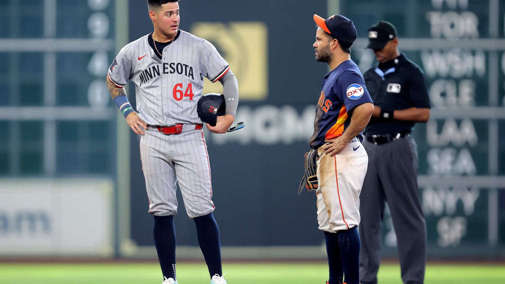 Minnesota Twins third baseman Jose Miranda stands on second base looking at Houston Astros second baseman Jose Altuve