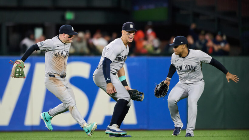 New York Yankees outfielders celebrating a win