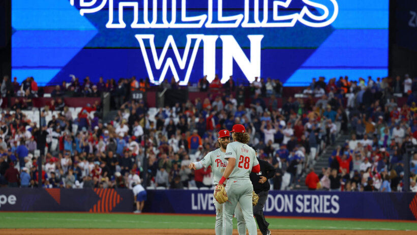 Philadelphia Phillies players Bryce Harper and Alec Bohm celebrate a win