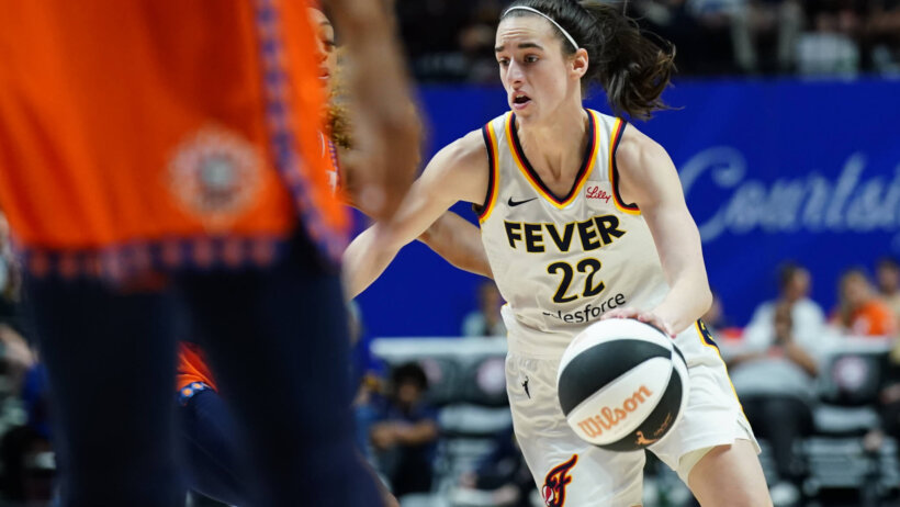 Indiana Fever guard Caitlin Clark dribbling up the court against the Connecticut Sun