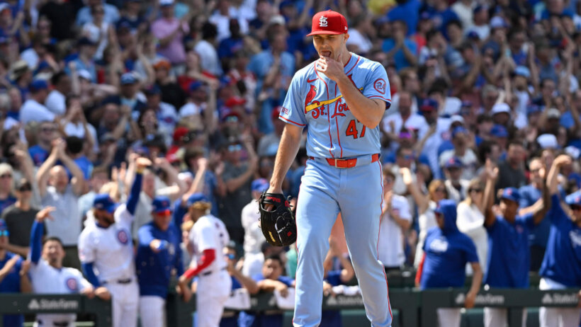 St. Louis Cardinals pitcher John King holds his glove over his mouth