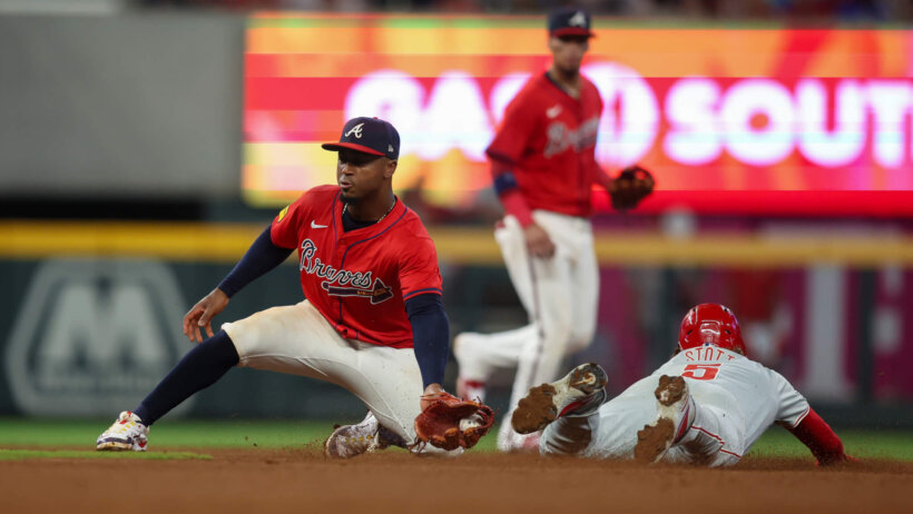 Philadelphia Phillies designated hitter Bryson Stott stealing second base against the Atlanta Braves