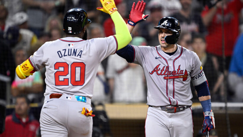Atlanta Braves designated hitter Marcell Ozuna is congratulated by right fielder Adam Duvall