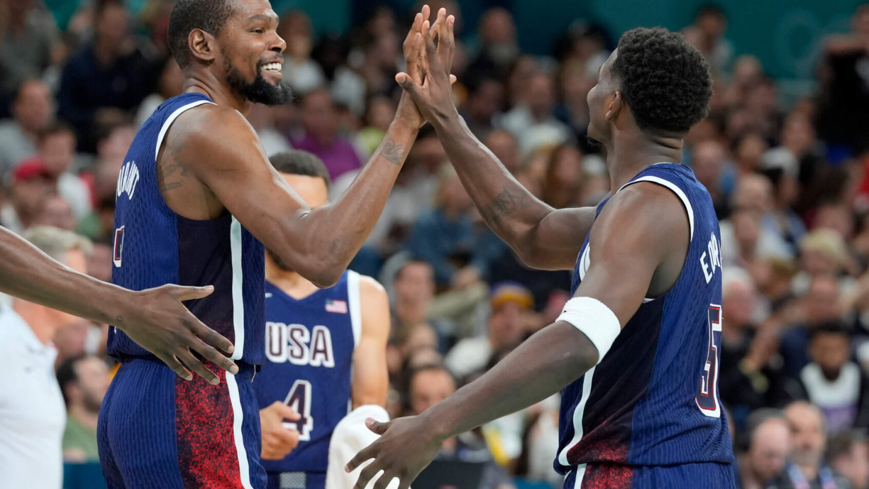 Team USA's Kevin Durant and Anthony Edwards high-fiving during a game against Serbia