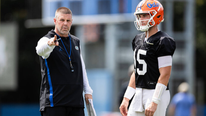 Florida Gators head coach Billy Napier talking to starting quarterback Graham Mertz during practice