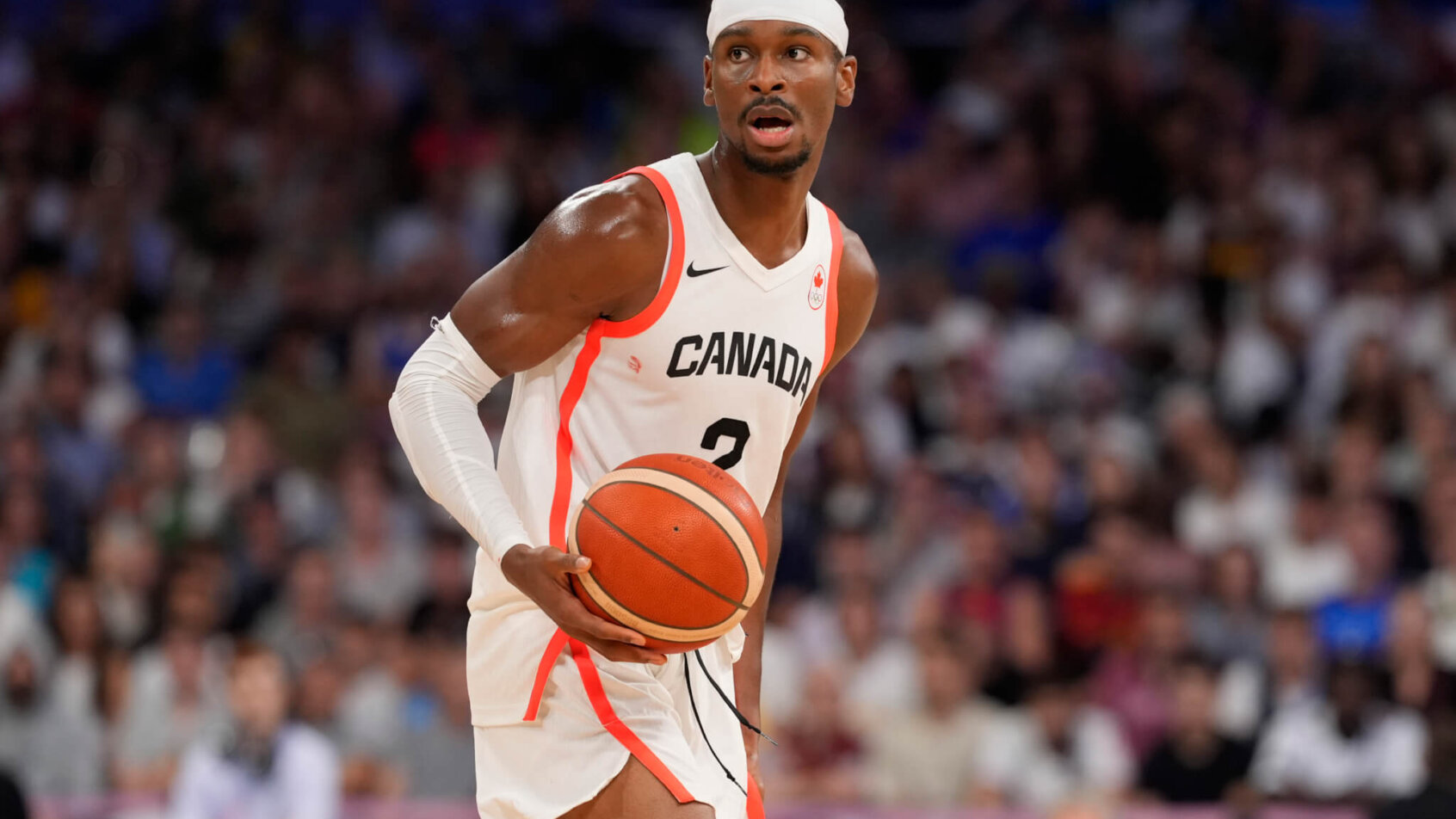 Canada guard Shai Gilgeous-Alexander dribbles up the court