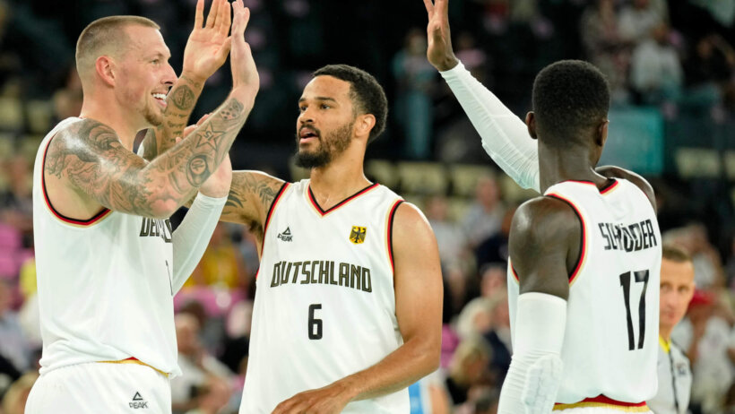 Germany's Daniel Theis, Nick Weiler-Babb, and Dennis Schroder high-fiving