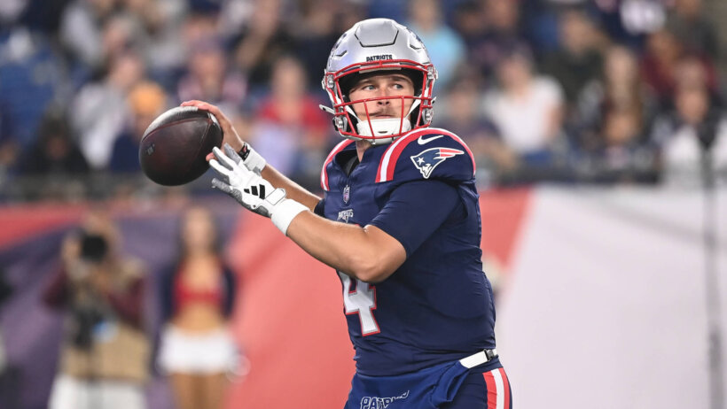 New England Patriots quarterback Bailey Zappe winds up to pass