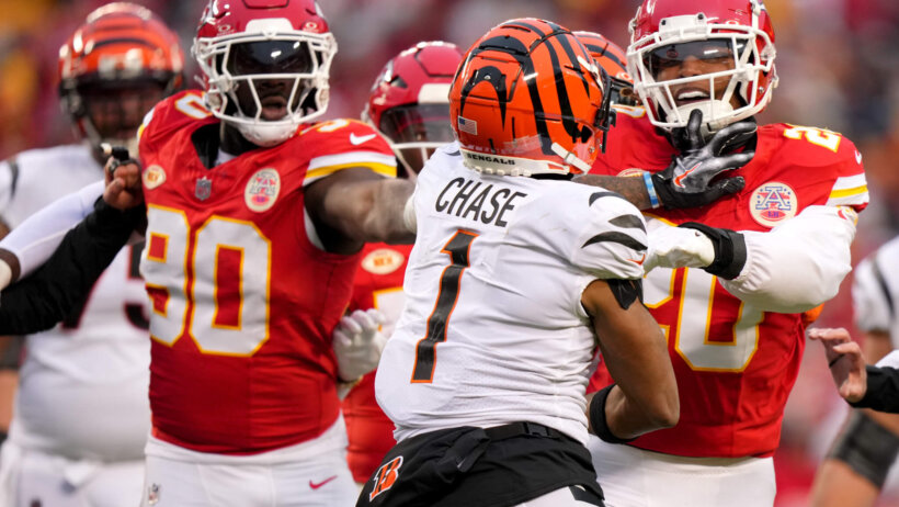 Cincinnati Bengals wide receiver Ja'Marr Chase jostles with Kansas City Chiefs safety Justin Reid