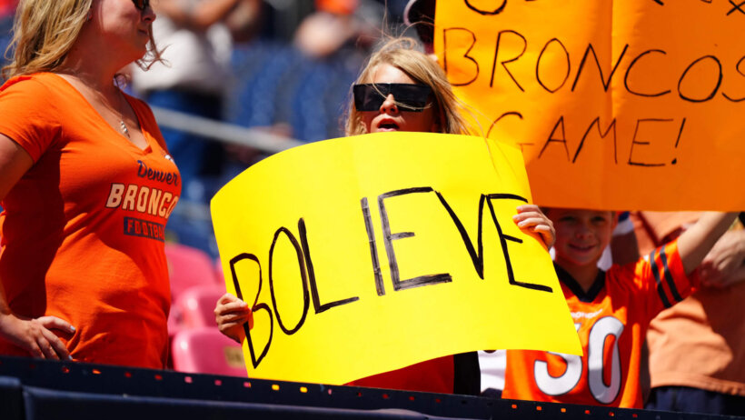 Broncos fan holding a Bolieve sign