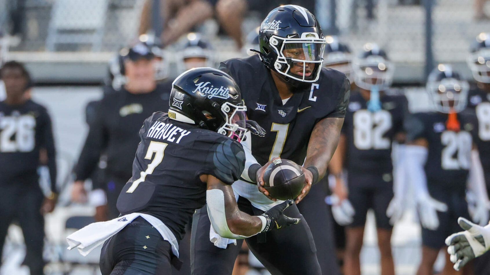 UCF Knights quarterback KJ Jefferson hands off to running back RJ Harvey