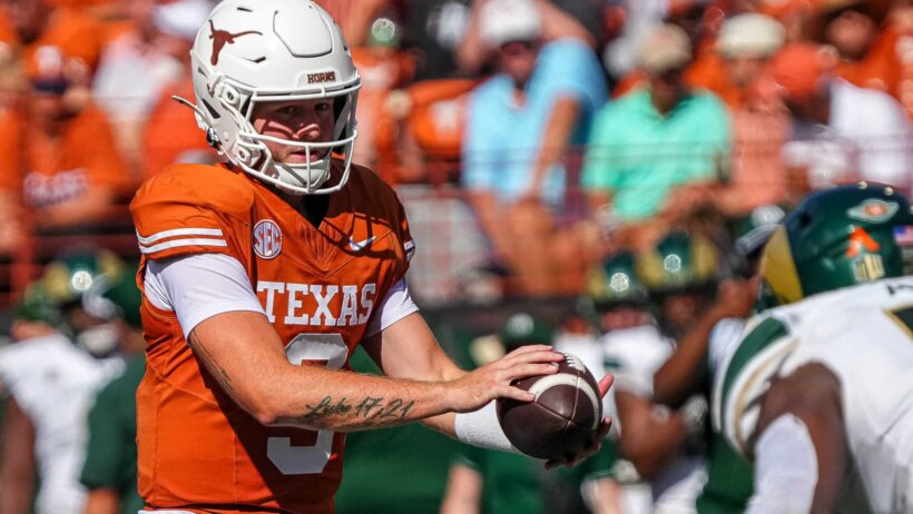 Texas Longhorns quarterback Quinn Ewers snaps the ball