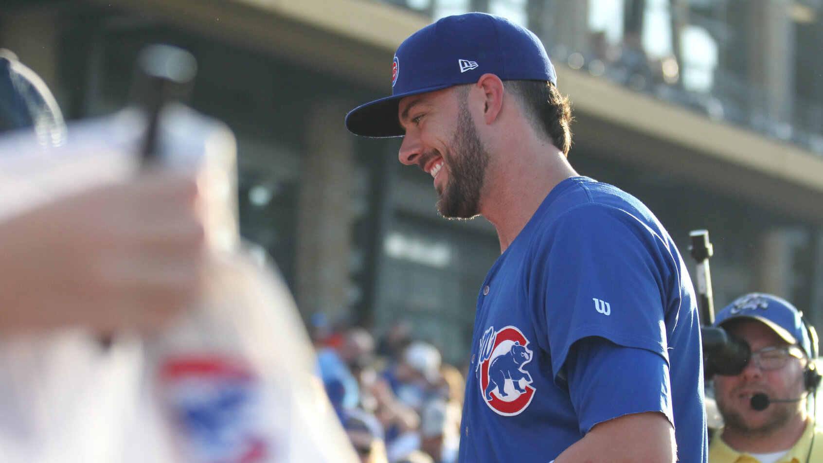 Kris Bryant signing autographs on the field