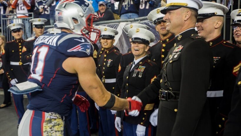 Julian Edelman shaking hands with a Marine