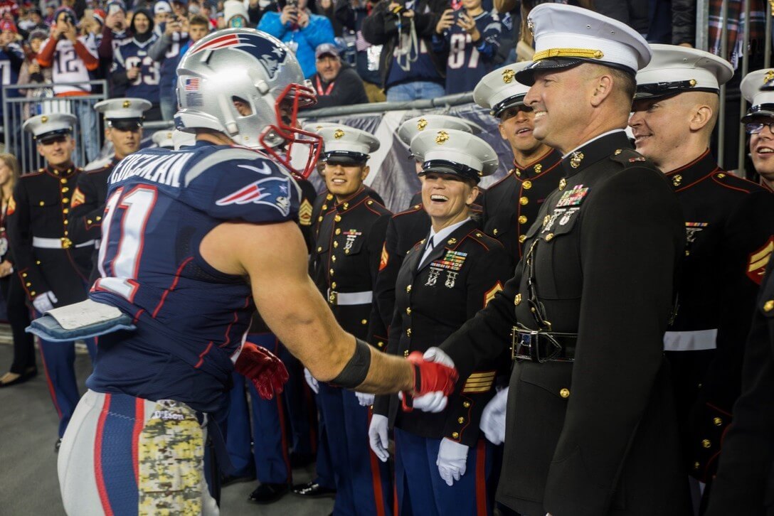 Julian Edelman shaking hands with a Marine