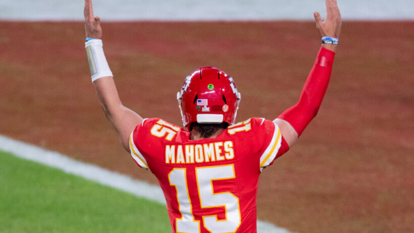 Patrick Mahomes with his hands raised