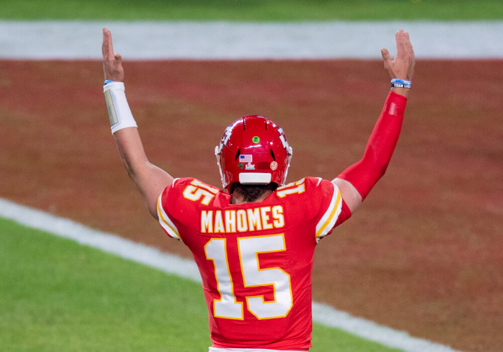 Patrick Mahomes with his hands raised