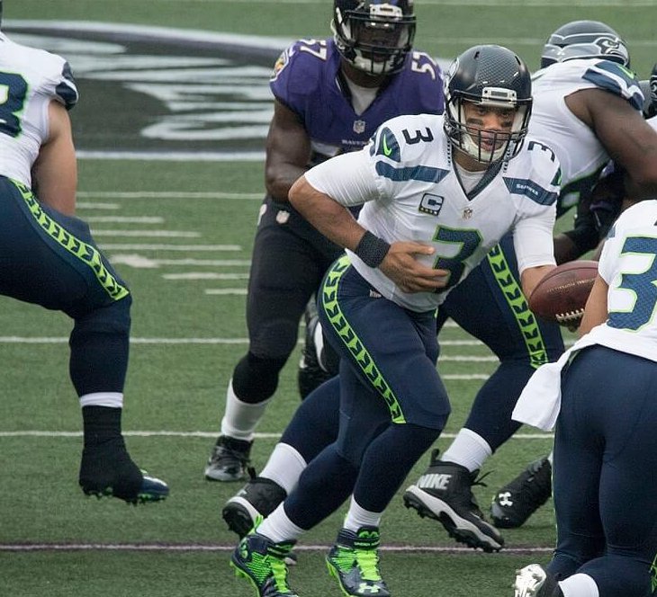 Russell Wilson handing the ball off.