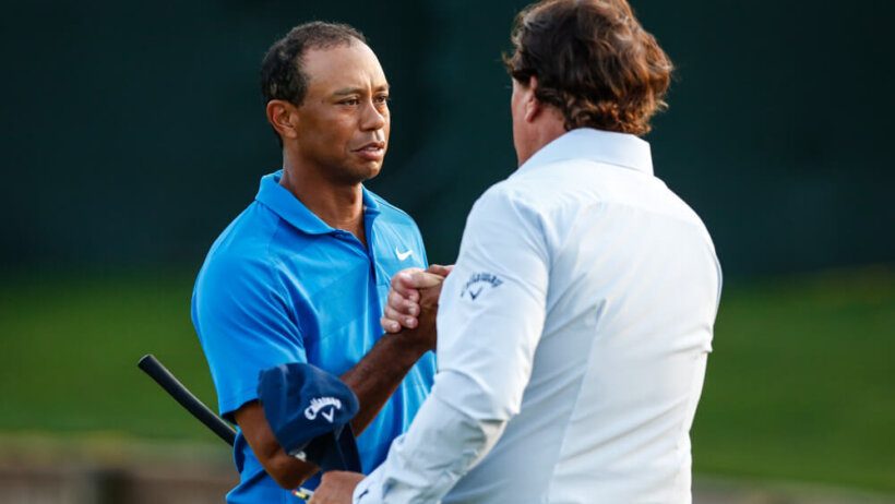 Tiger and Phil embrace