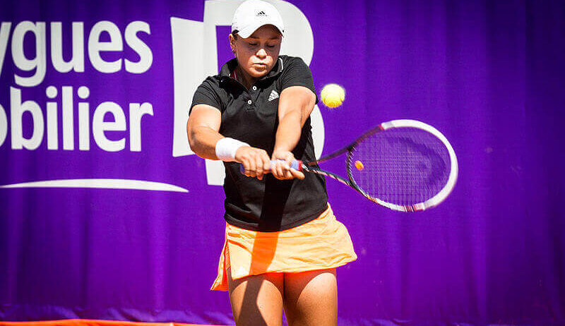 Ashleigh Barty hitting a return shot