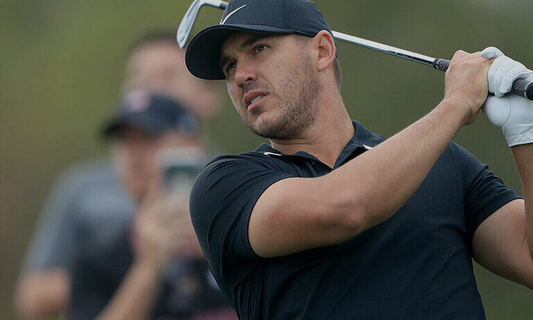 brooks koepka swinging a golf club