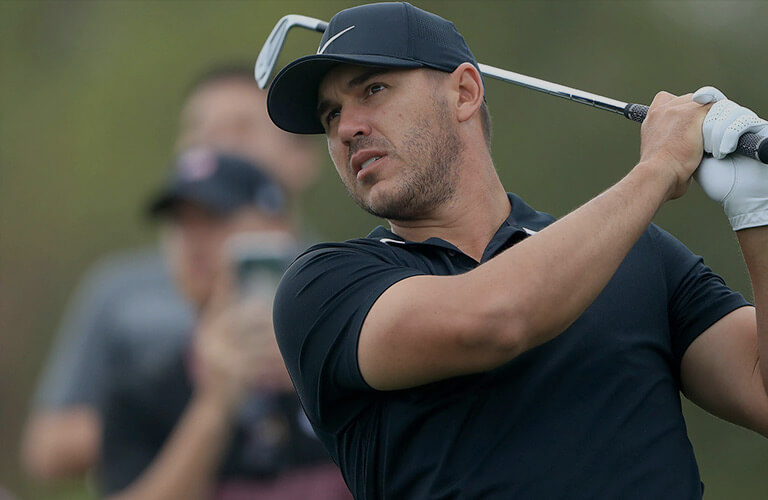brooks koepka swinging a golf club