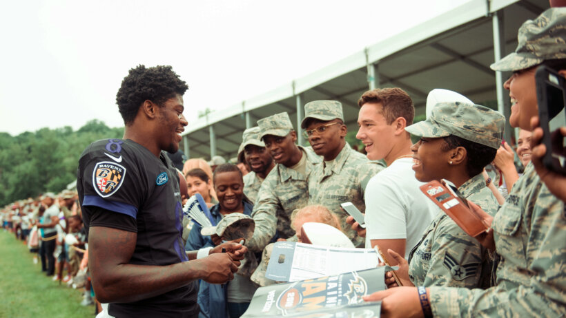 Lamar Jackson signing autographs for fans