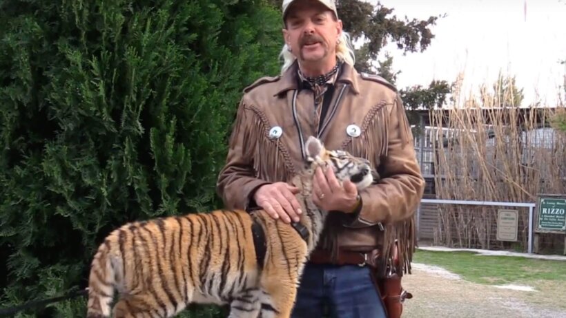 Joe Exotic posing with a tiger