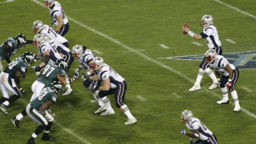 Tom Brady taking a snap for the New England Patriots